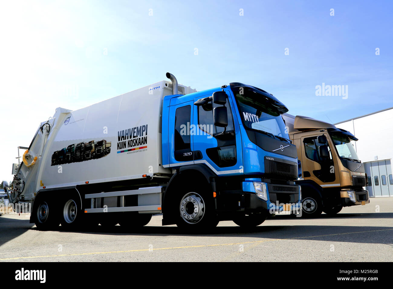 LIETO, FINLAND - APRIL 5, 2014: New Volvo FE 6x2 320 and FL512 4X2 trucks displayed as part of the new Volvo Truck range at Volvo Truck and Bus Center Stock Photo