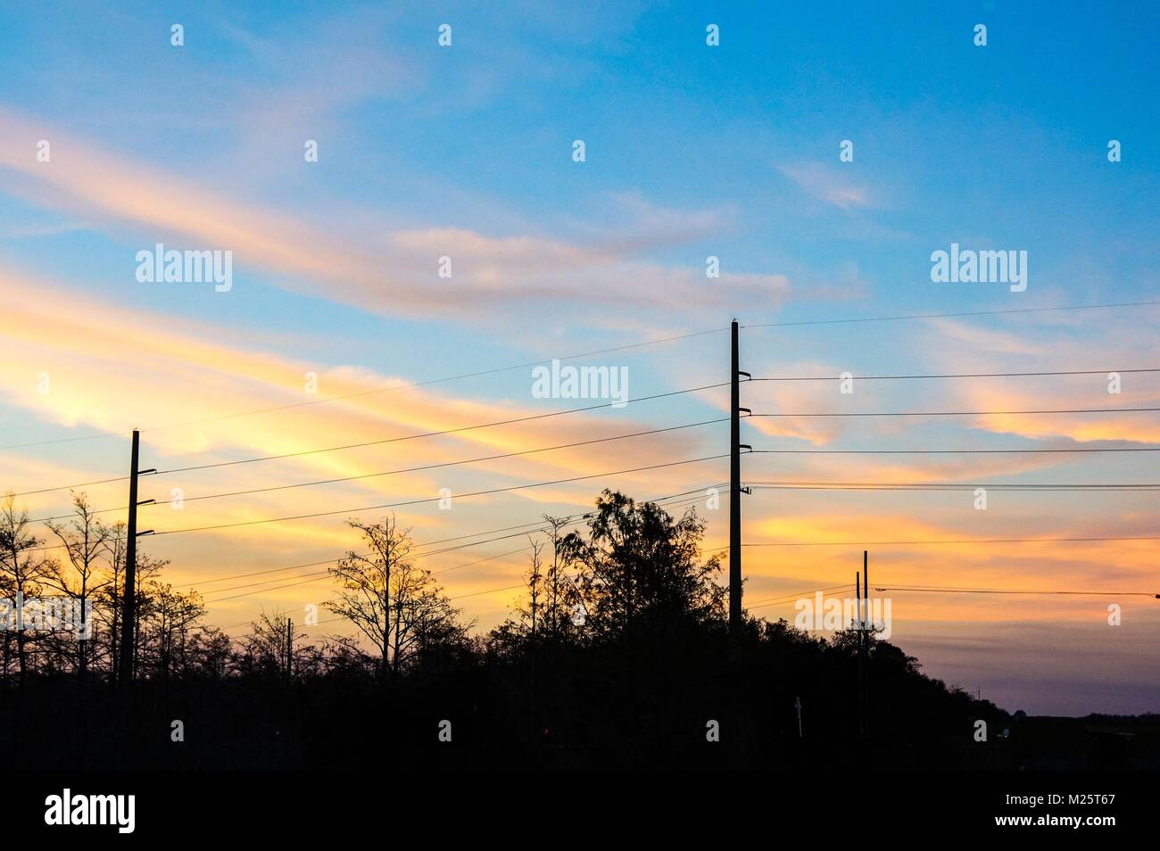 sunset sky and silhouette of power lines in the country Stock Photo - Alamy