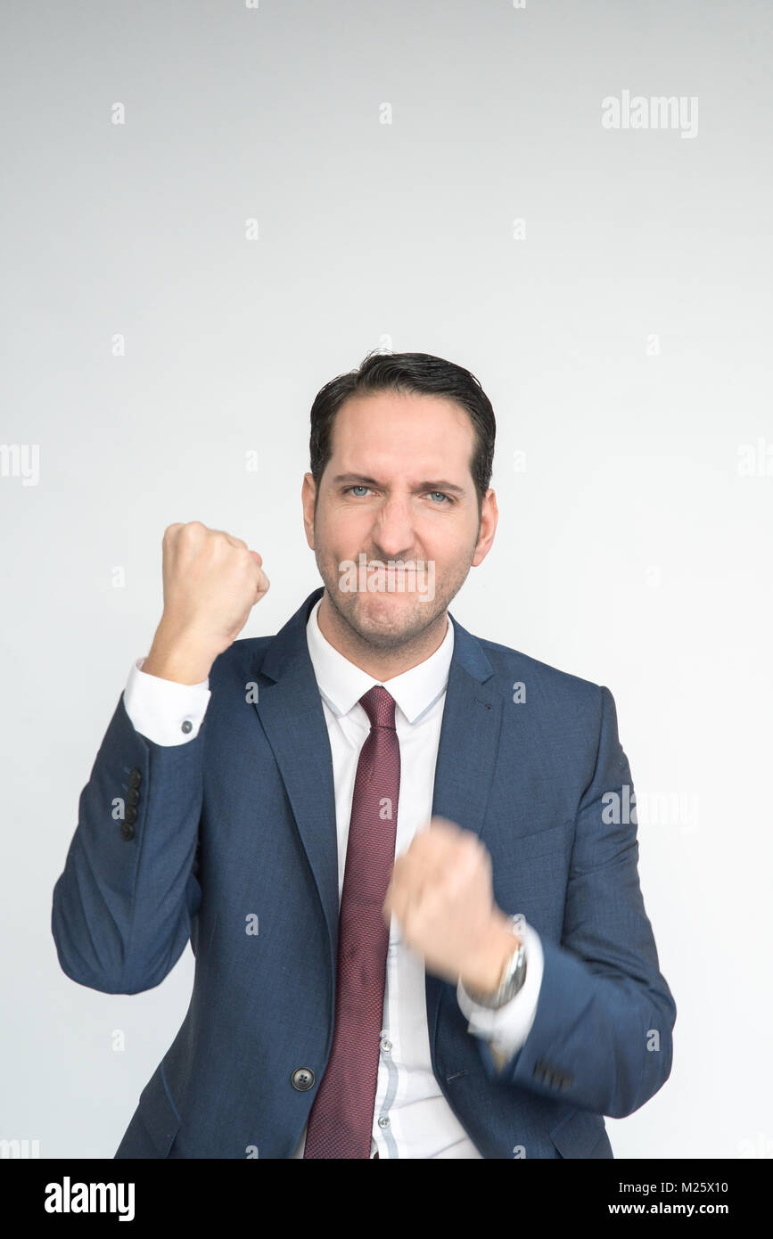 Excited well dressed man punches the air looking happy and excited