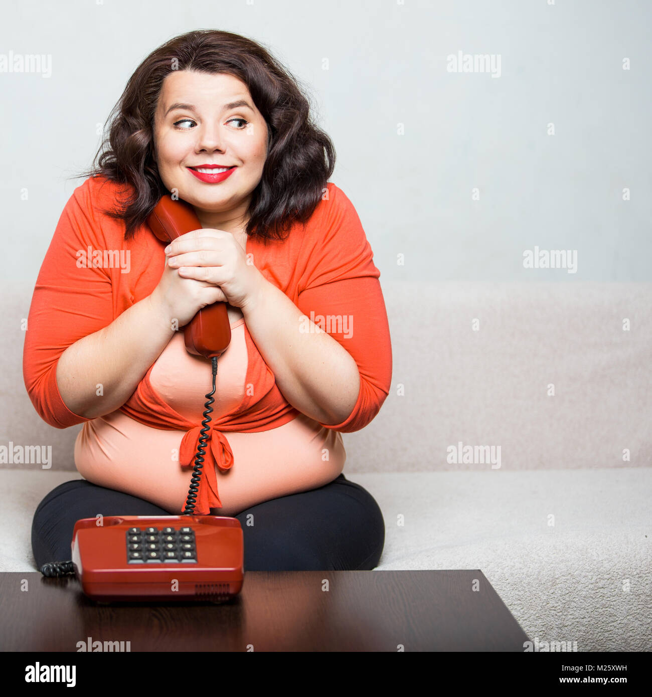Portrait of a happy fat woman with phone Stock Photo
