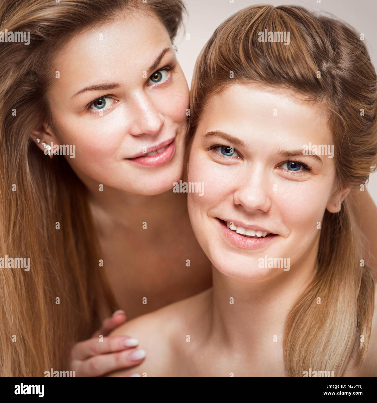 Portrait of two beautiful young smiling women closeup Stock Photo