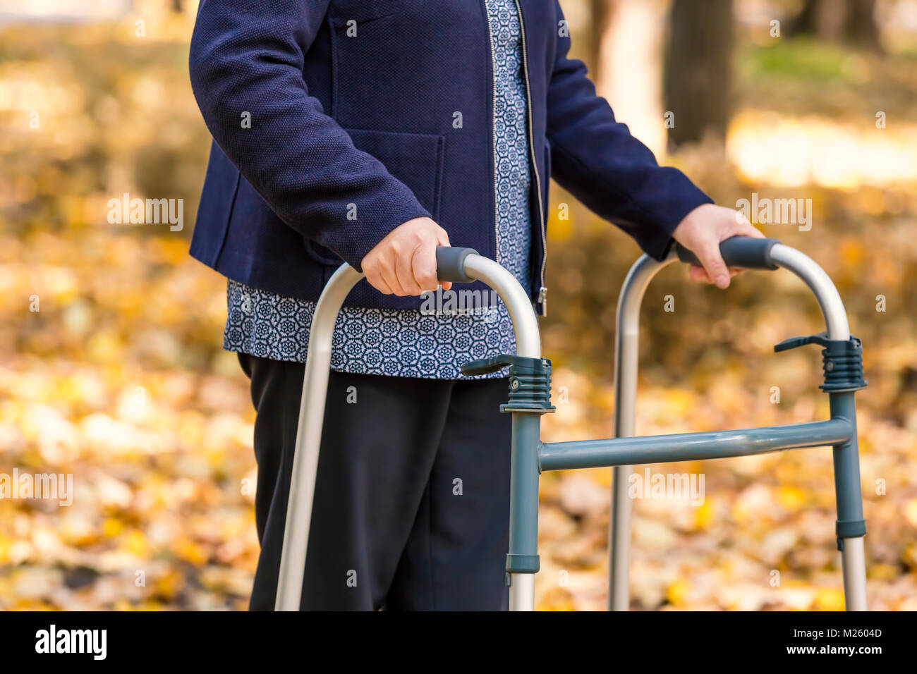 Senior woman walking in park hi-res stock photography and images - Alamy