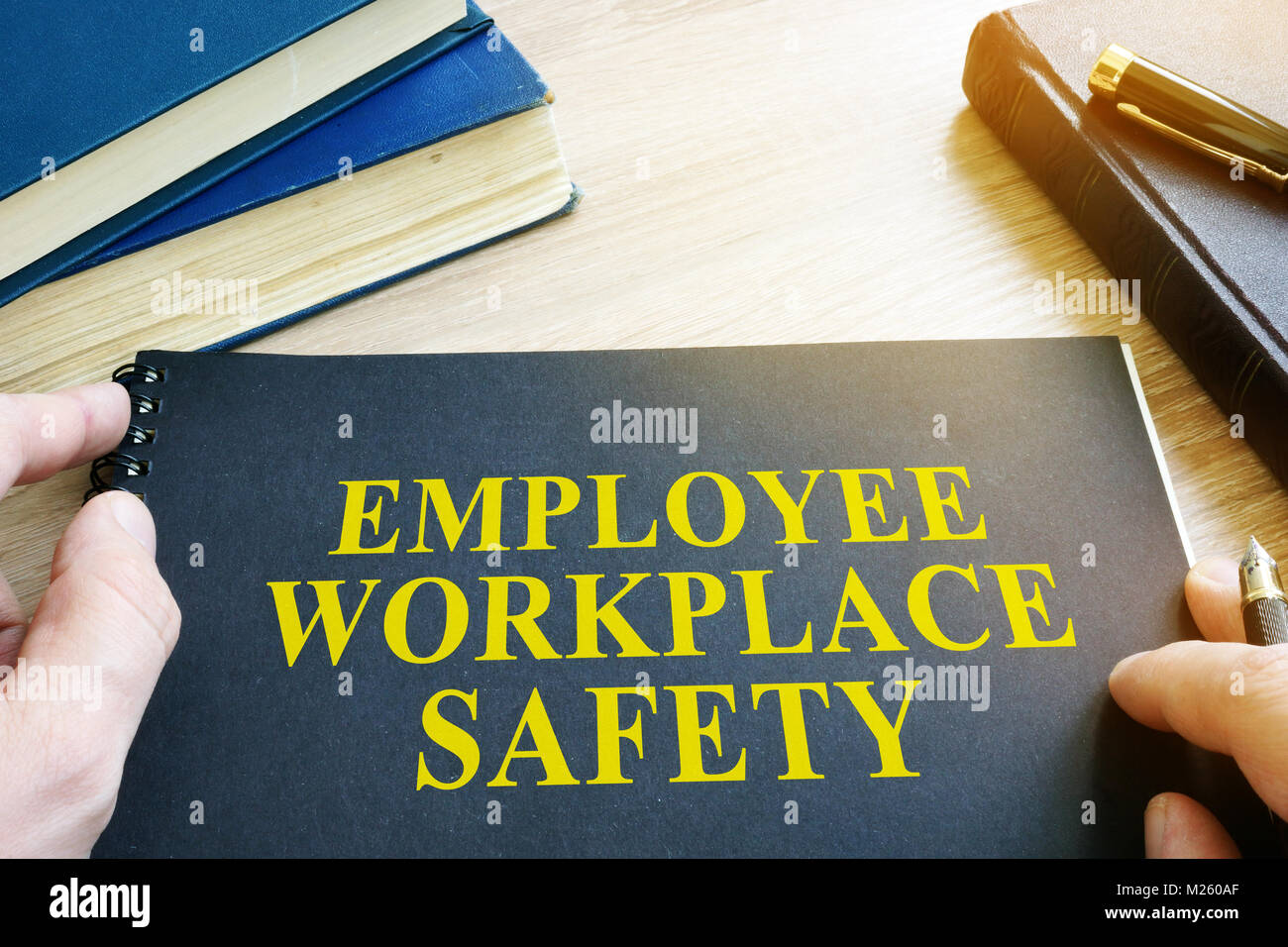 Employee Workplace Safety guide on a table. Stock Photo
