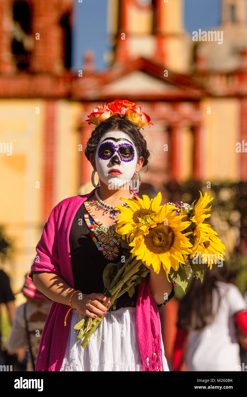 CADEREYTA, MEXICO - OCTOBER 27 mexican girl with catrina makeup and  Catrina dress holding sunflowers Stock Photo