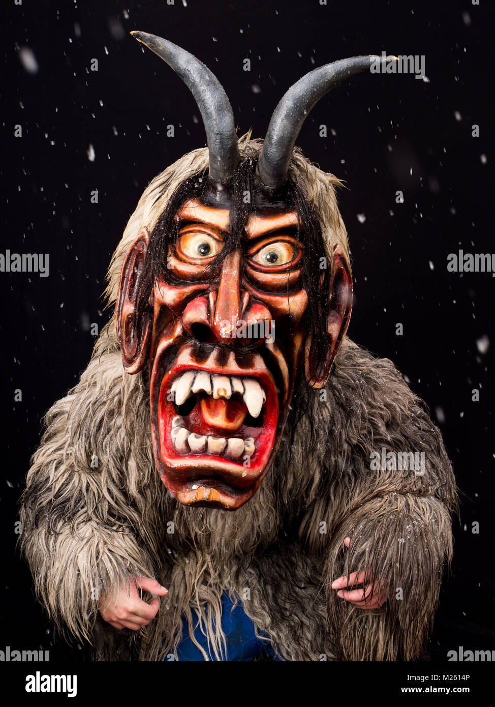 Krampus, mask with origin in Alp mountains, used in German speaking countries. Mystical pagan characters appear in streets of European towns and villages, especially at the end of winter when spring is about to come and people need somebody who would chase the winter away. Wearing a mask is a part of identity in many communities. They preserve traditions and mysterious characters inherited from their fathers and grandfathers. Each has his or her own task. The traditions vary from village to village and are incredibly diverse. In Ptuj, Slovenia, each year before Shrove Wednesday, masked charact Stock Photo
