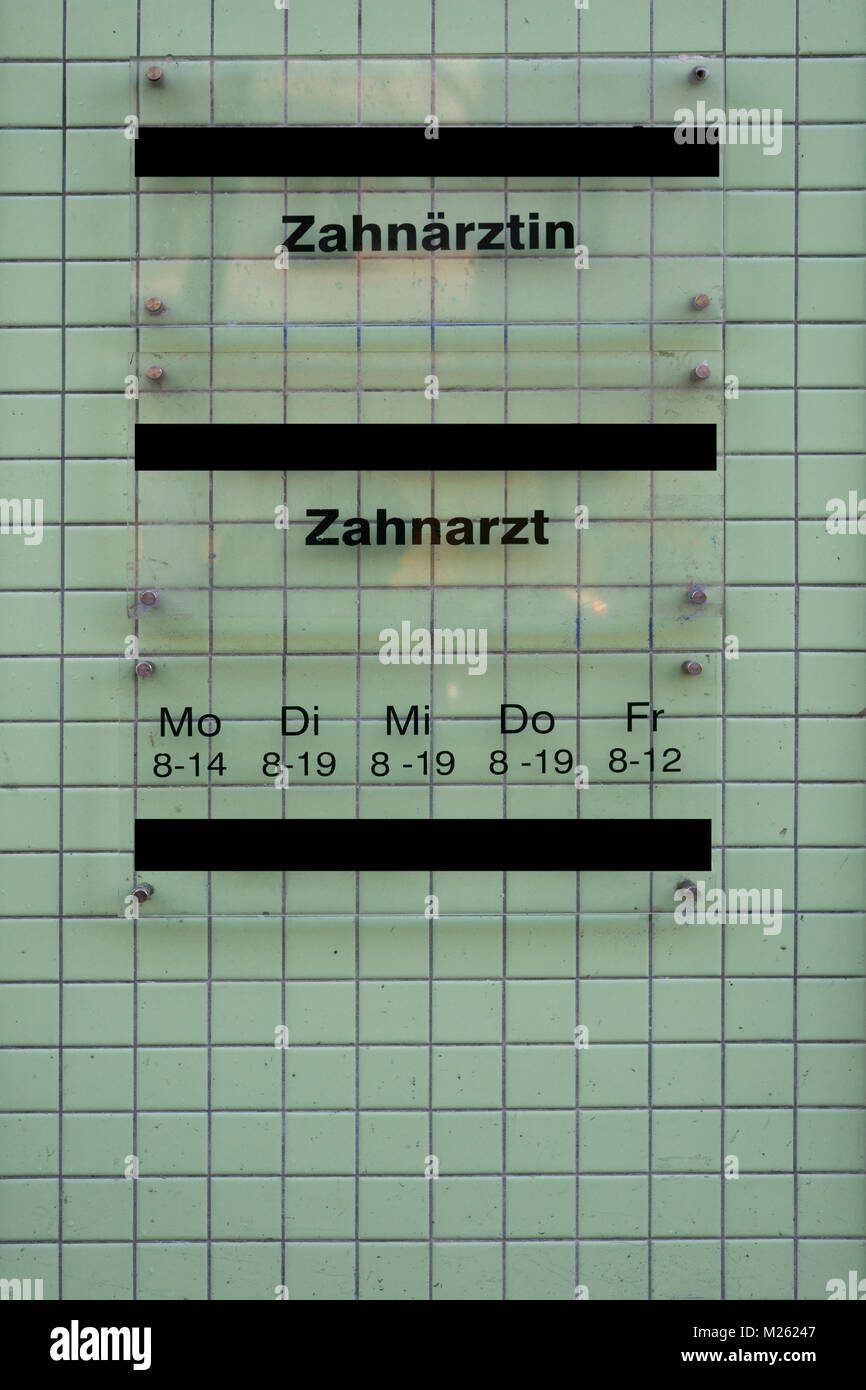 The closeup of a translucent sign with the opening hours of dentists