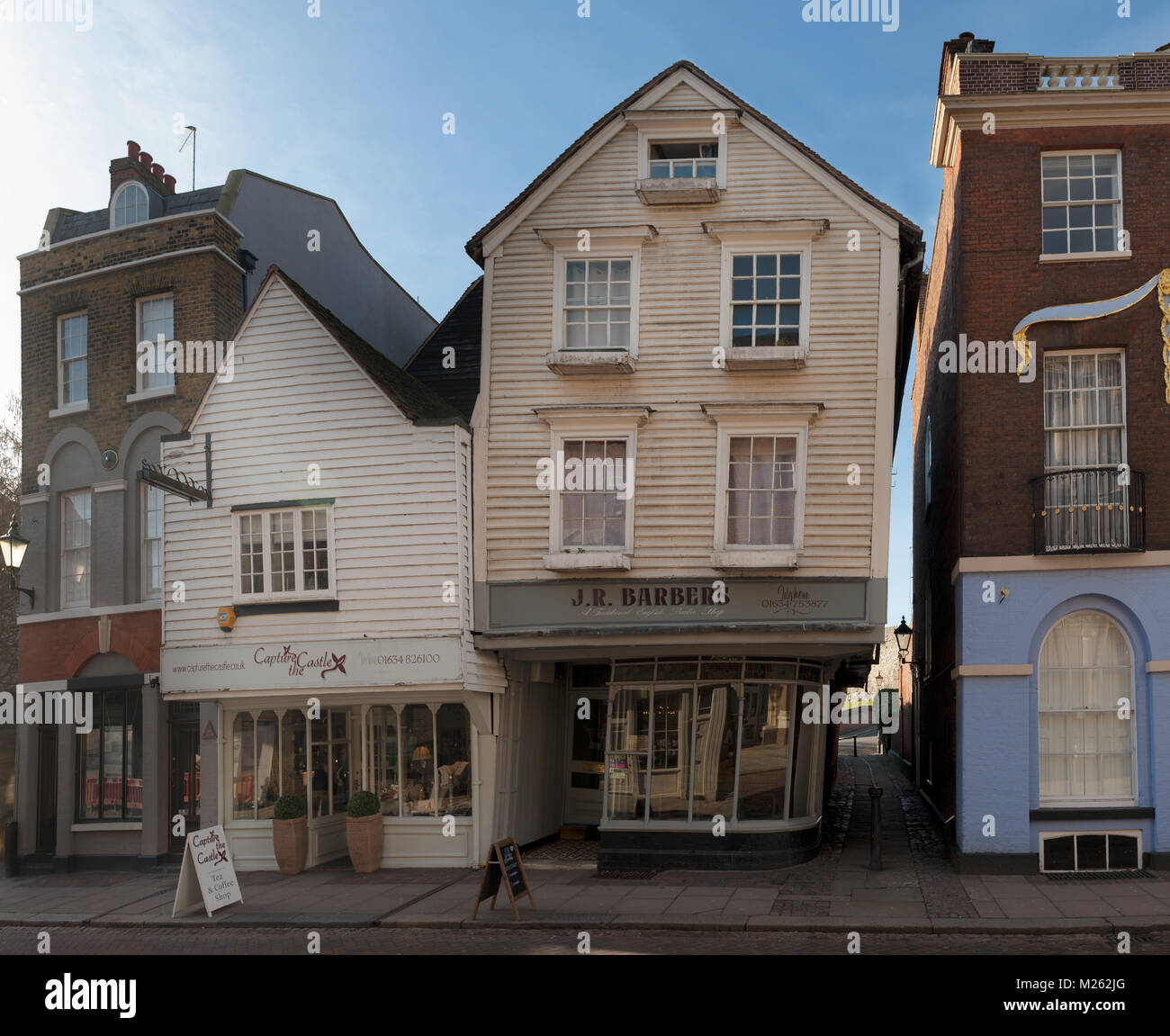 J R Barbers salon, an old timber framed high street building that  is moving and leaning over pulling away from the joining property, needs tying back Stock Photo