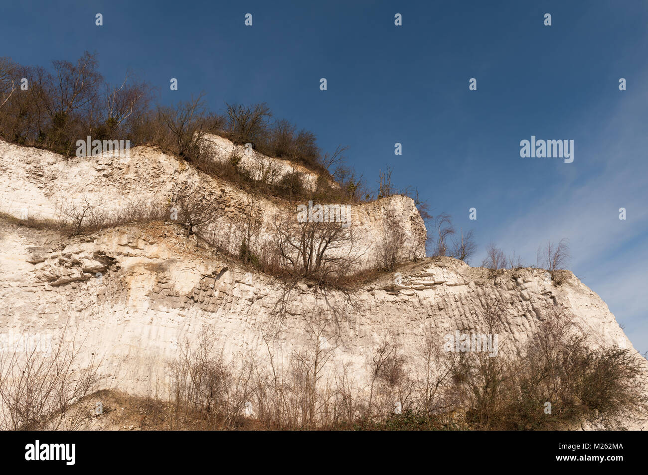 Chalk pit face to mined hillside used to extract chalk used for making lime and cement in