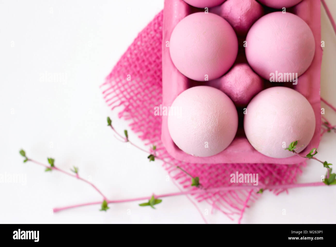 Pink easter eggs in pink box with decoration, on white background with copy space; easter wallpaper Stock Photo
