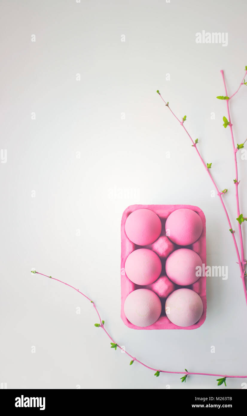 Pink easter eggs in pink box with decoration, on white background with copy space; easter wallpaper Stock Photo