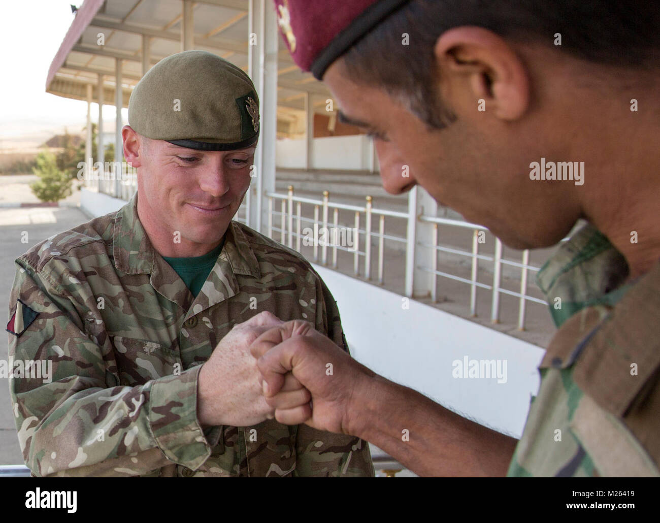 A British army trainer and a Peshmerga officer fist bump during ...