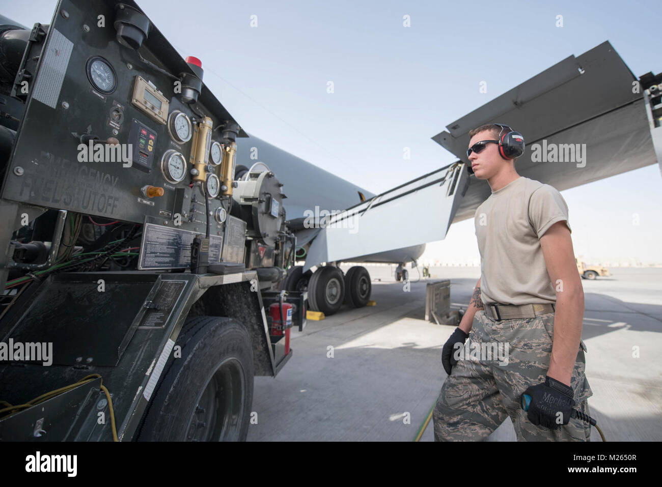 U.S. Air Force Airman Austin Collings, fuels distribution specialist assigned to the 379th Expeditionary Logistics Readiness Squadron, watches  gauges as he refuels a KC-135 Stratotanker at Al Udeid Air Base, Qatar, Jan. 23, 2018. Collings is using an R-12 fuel truck to fuel the KC-135 that is assigned to the 340th Expeditionary Air Refueling Squadron , which is responsible for delivering two-thirds of all fuel to airborne receivers in the U.S. Central Command’s area of responsibility.   (U.S. Air National Guard Stock Photo