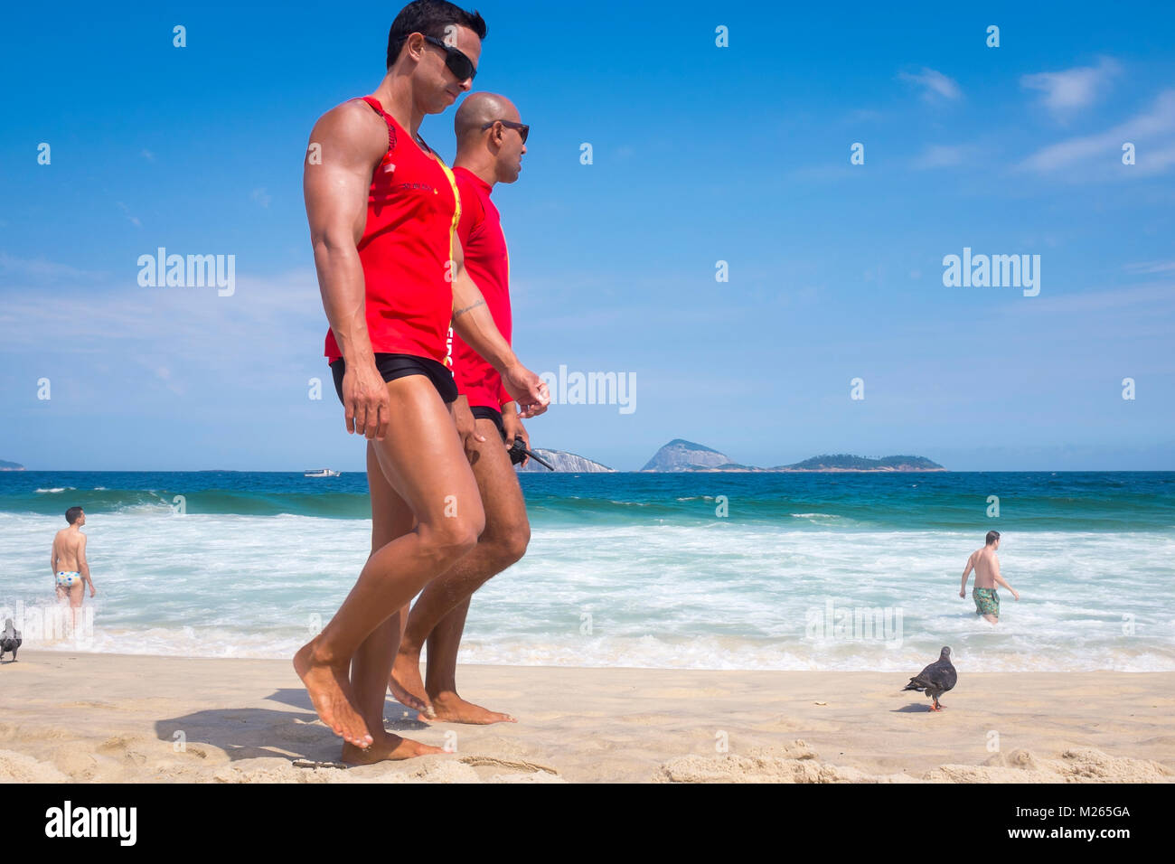 RIO DE JANEIRO - FEBRUARY 05, 2017: A pair of Brazilian lifeguards pass on a walking patrol of Ipanema Beach. Stock Photo