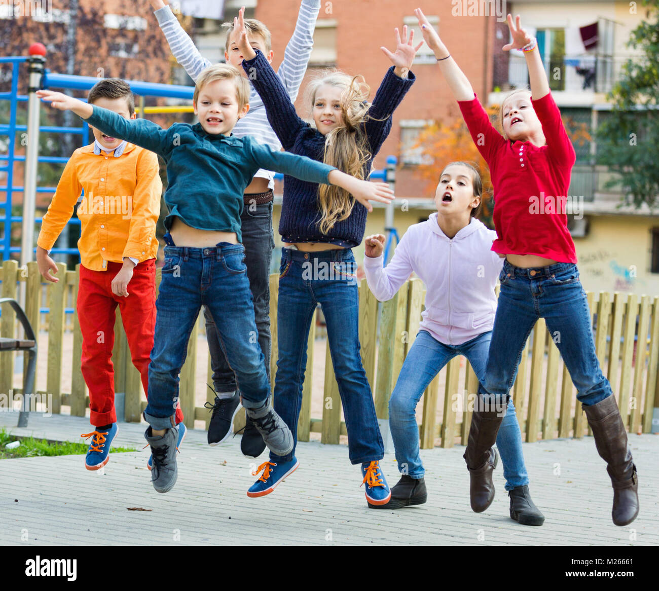 Happy positive kids having fun and jumping up Stock Photo - Alamy
