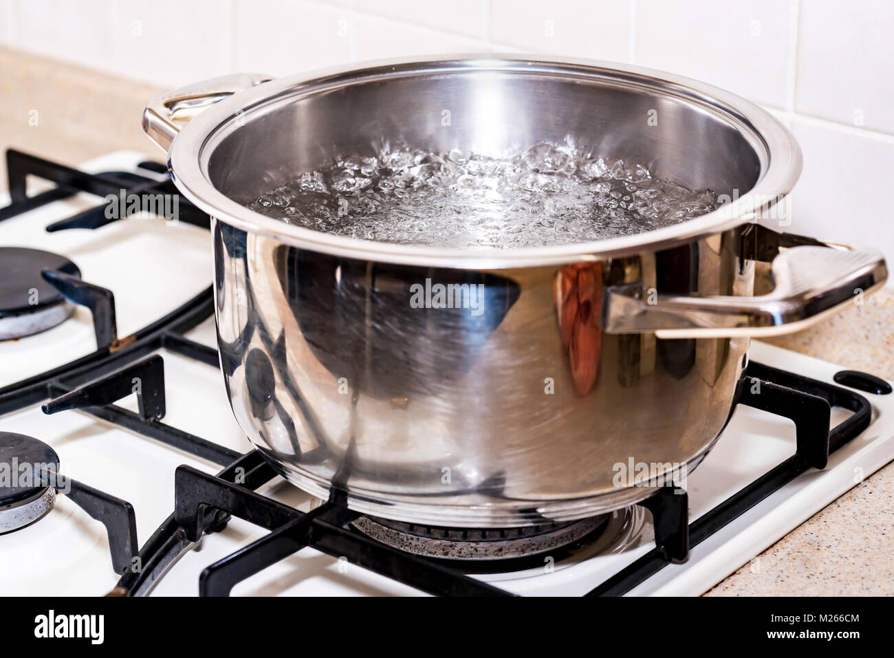 Boiling water for soup in modern saucepan Stock Photo Alamy