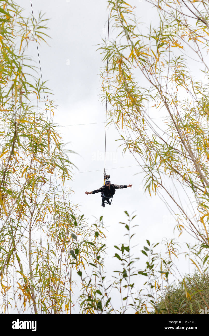 A woman experiencing the Eden Project Skywire. Bodelva, Cornwall, United Kingdom. Stock Photo