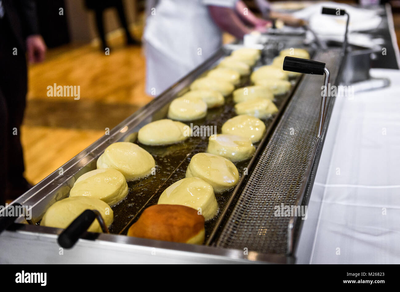 Making homemade jam doughnuts in a professional restaurant buffet
