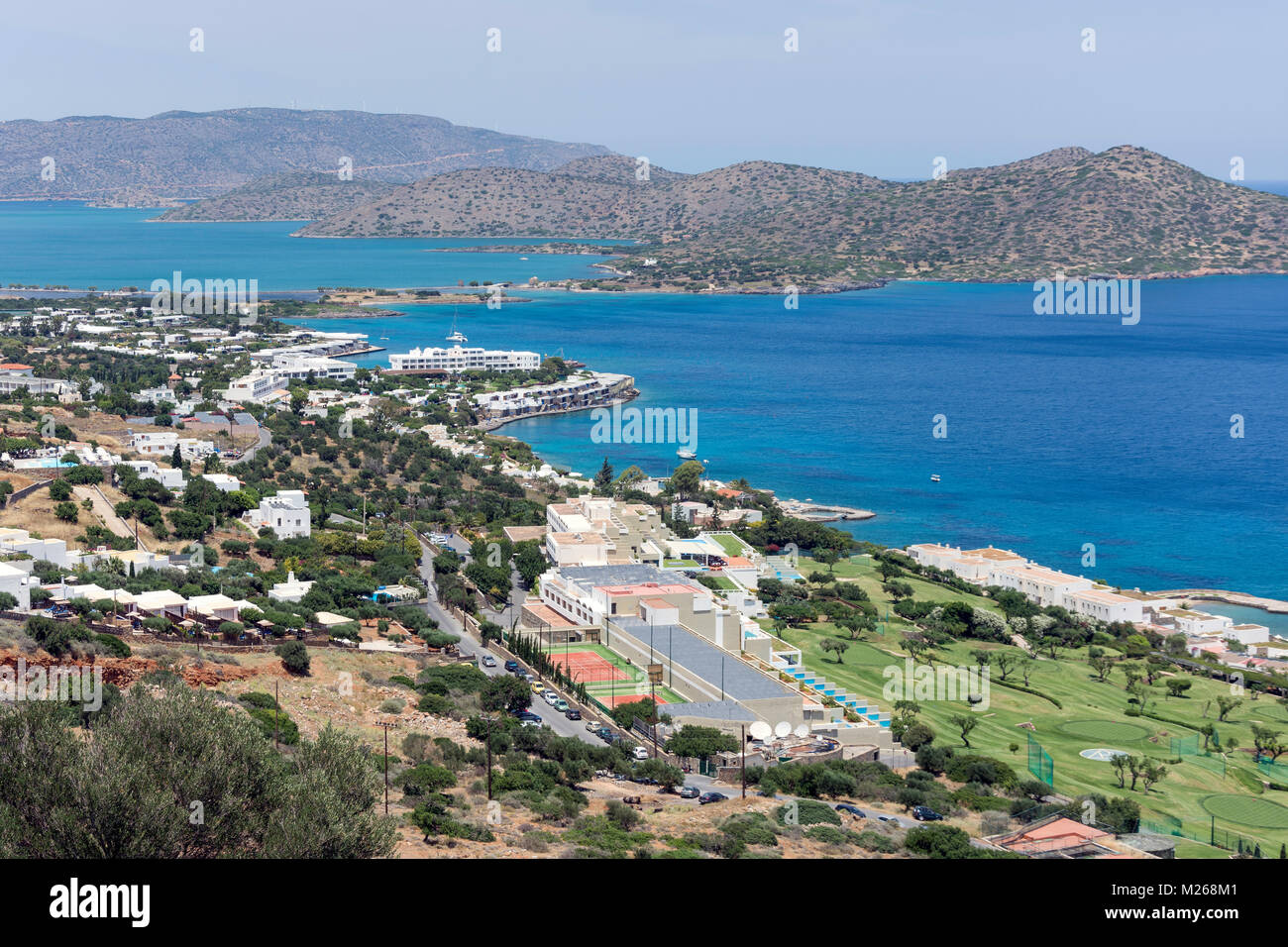 View of town and Porto Elounda Golf Course,  Elounda, Lasithi Region, Crete (Kriti), Greece Stock Photo