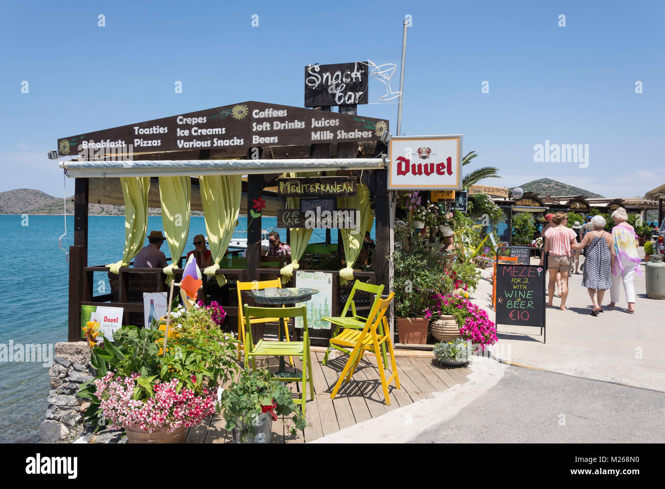 Tavernas on harbourfront, Elounda, Lasithi Region, Crete (Kriti), Greece Stock Photo