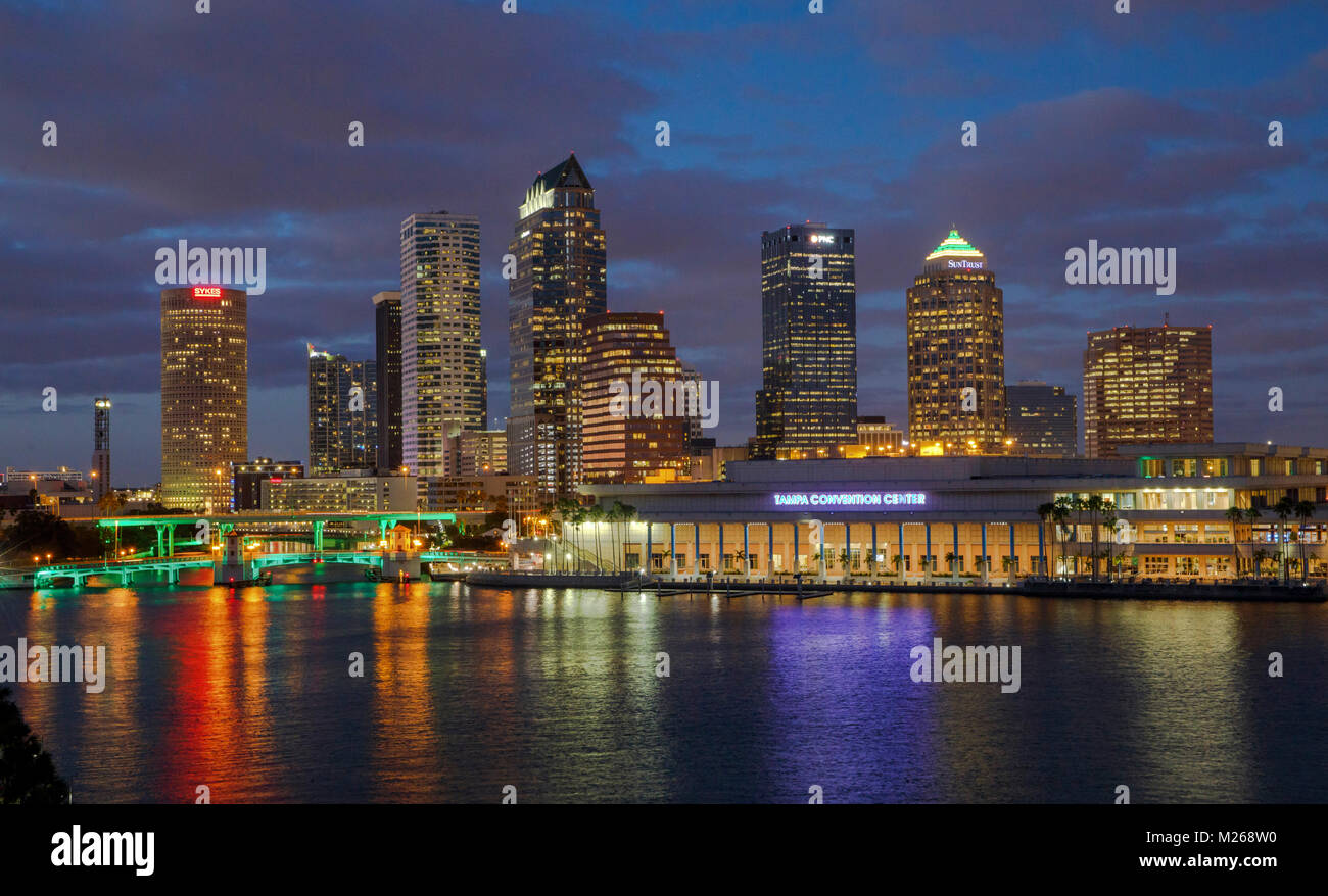 JANUARY 25, 2017 - TAMPA, FLORIDA:  The bridges along Tampa's Riverwalk are illuminated as the sun sets on the skyline of downtown Tampa, Florida. (Ph Stock Photo