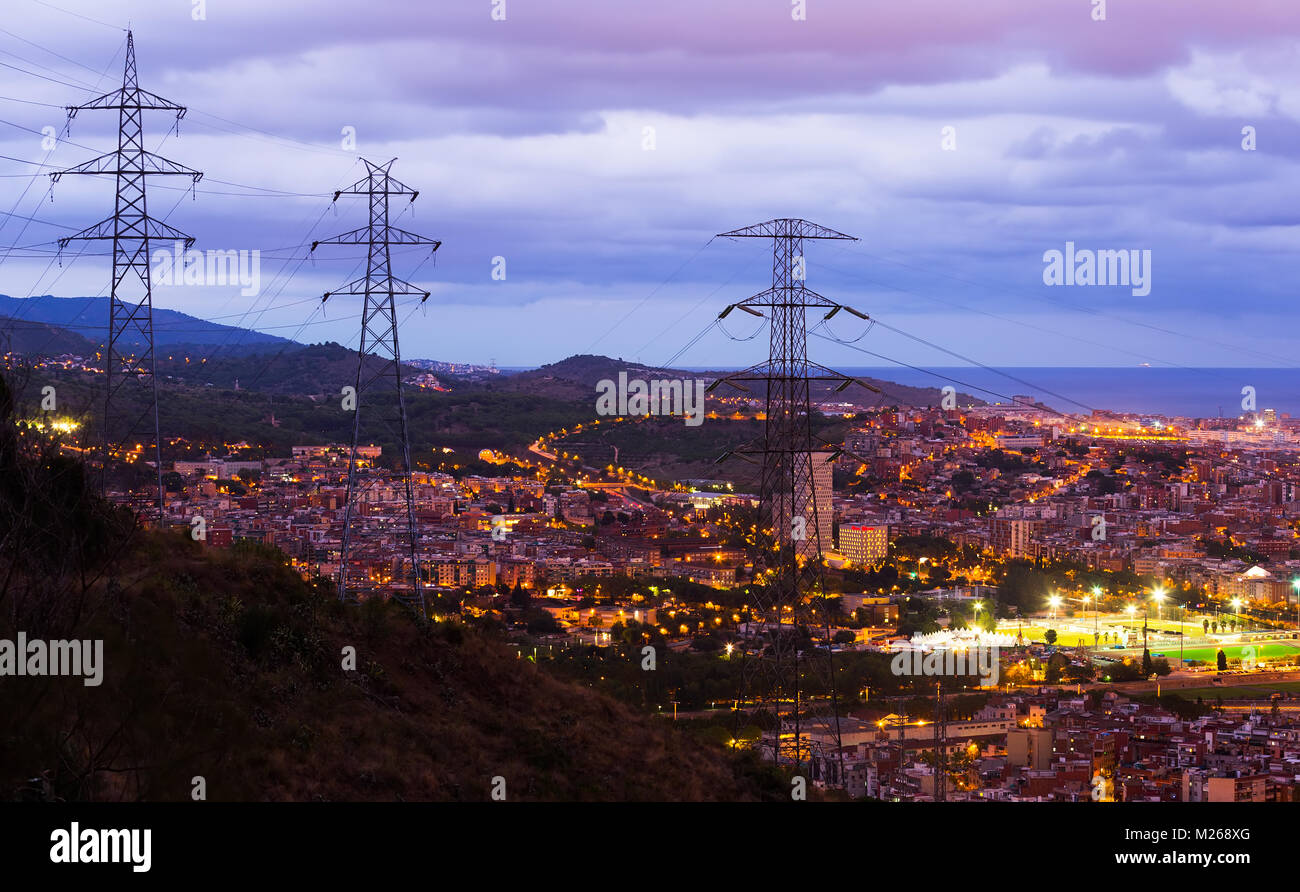 Aerial view of illuminated Barcelona with highvoltage transmission