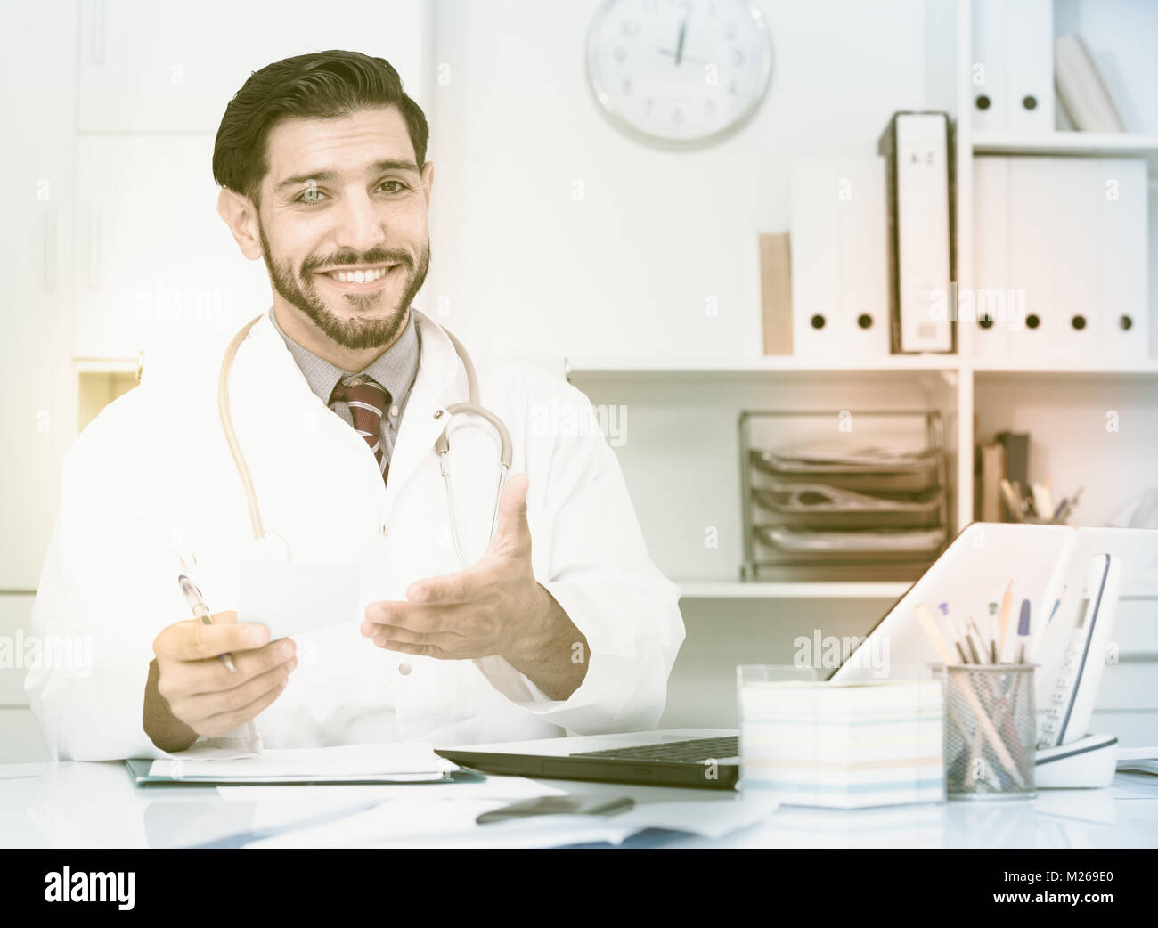 Spanish man therapist is giving opinion to client in hospital Stock