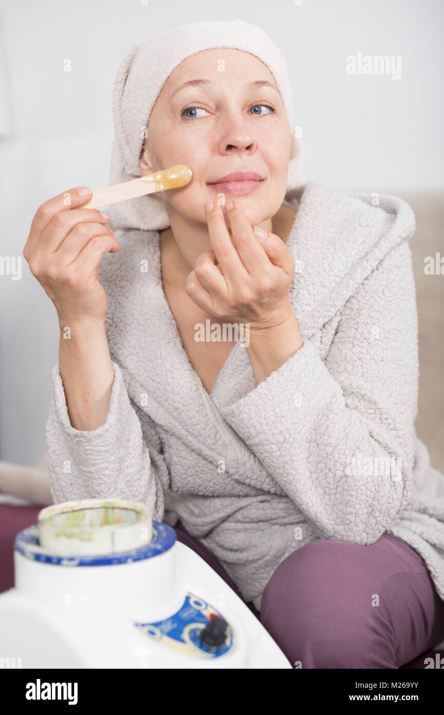 Senior woman starting body hair removal at home Stock Photo Alamy
