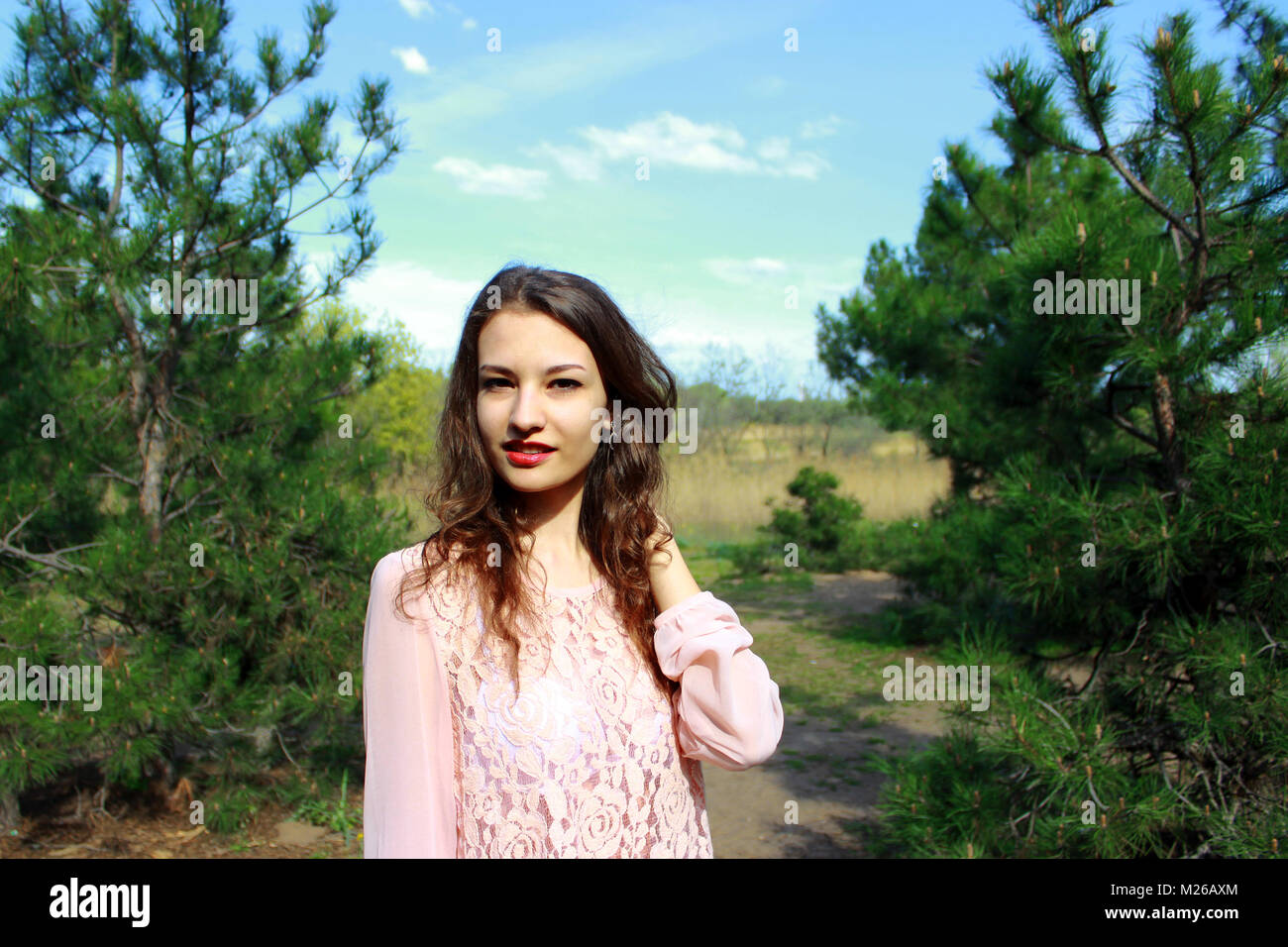 Beautiful blonde girl in a pink dress on nature background Stock Photo ...