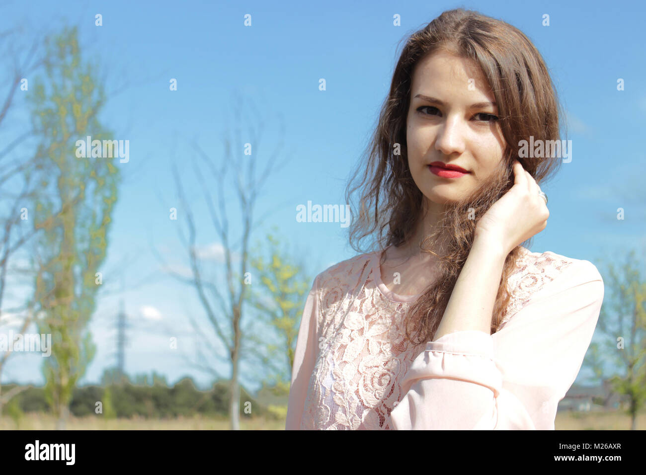 Beautiful girl in a pink dress in field Stock Photo - Alamy