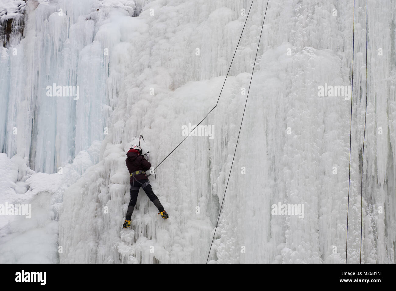 Climbing a frozen waterfall in Canada Stock Photo