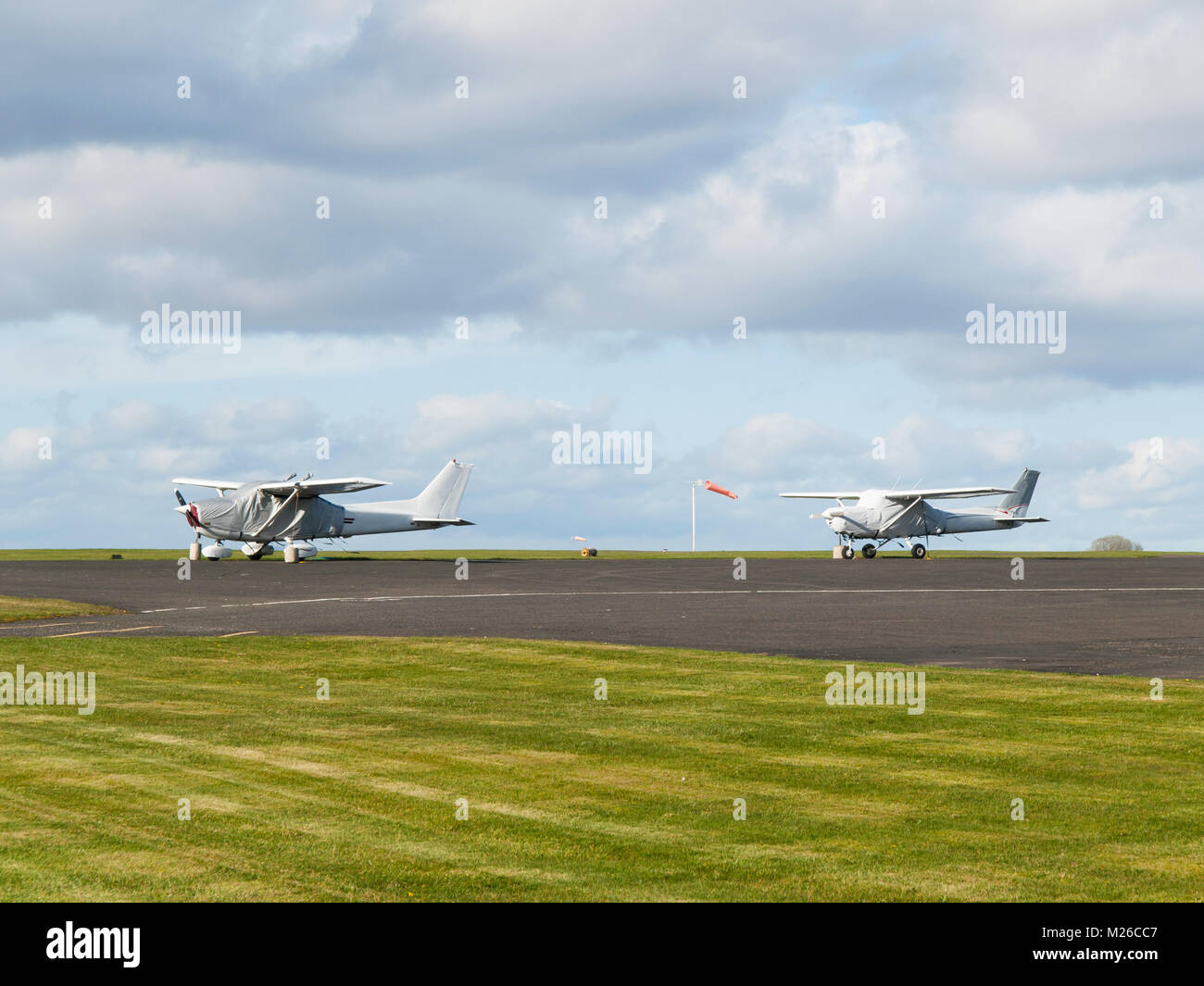 Small sport single-engine planes parked on runway Stock Photo