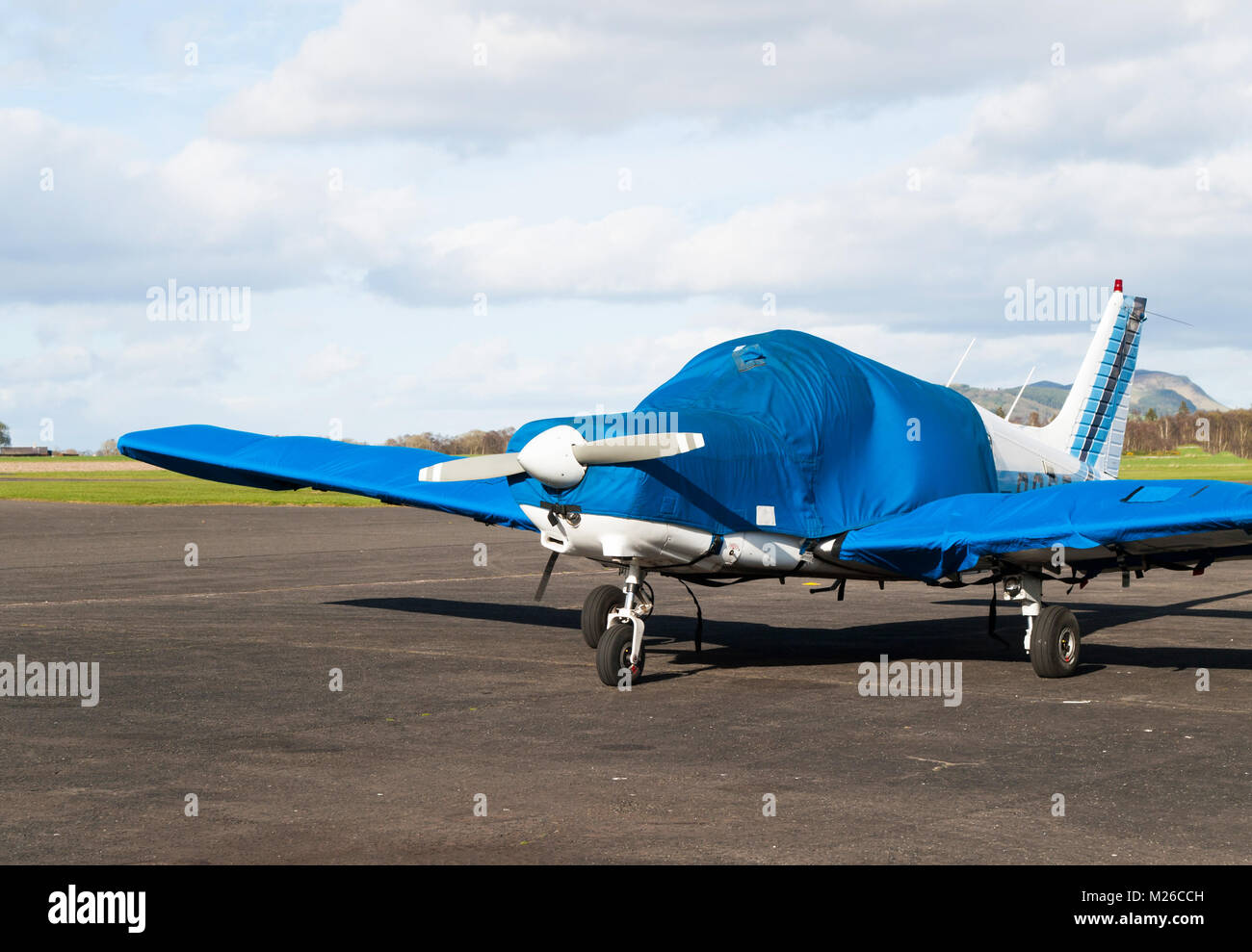 Small sport airplane stay parked on airport runway Stock Photo