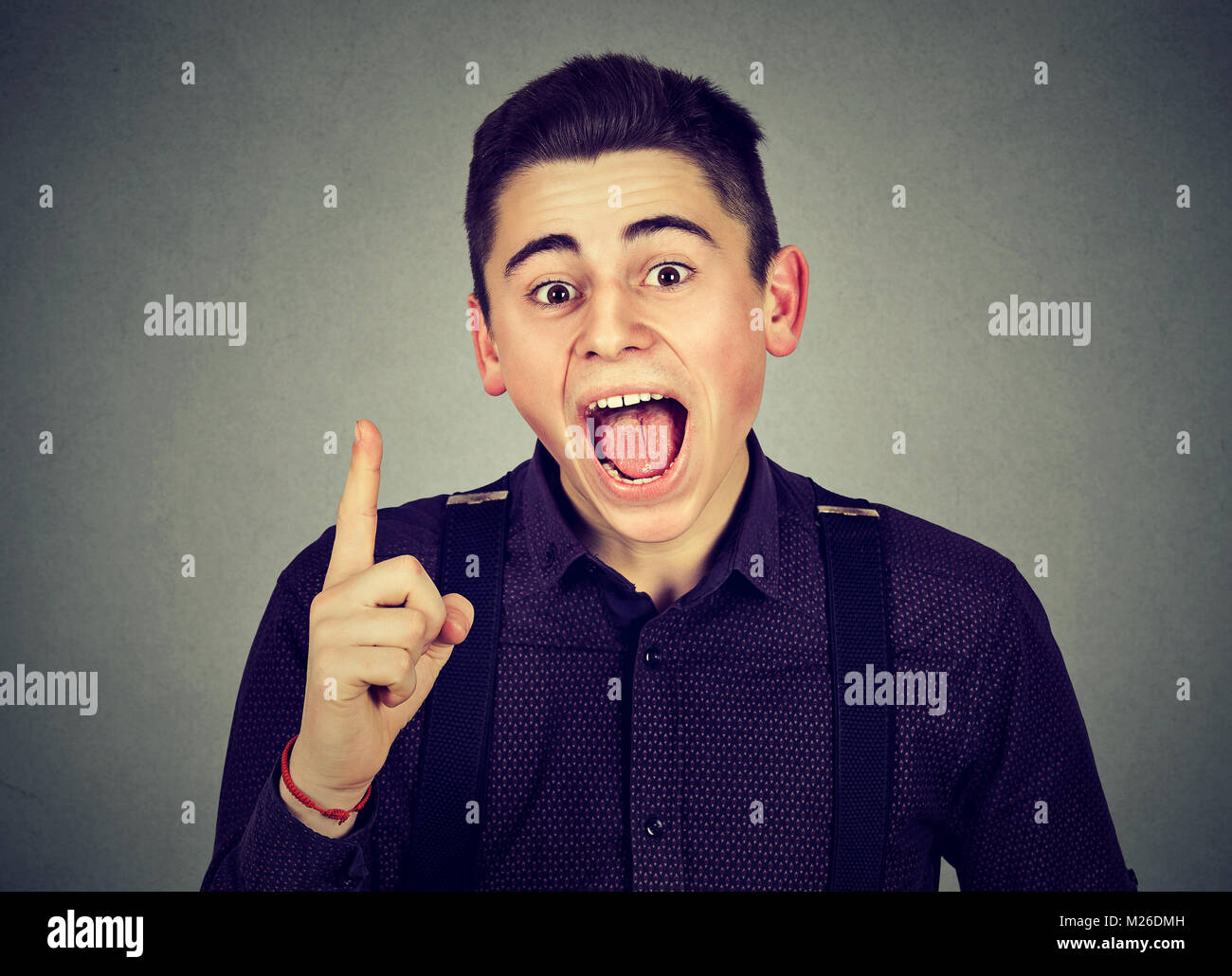 Young casual man gesturing in excitement having brilliant idea and looking at camera. Stock Photo