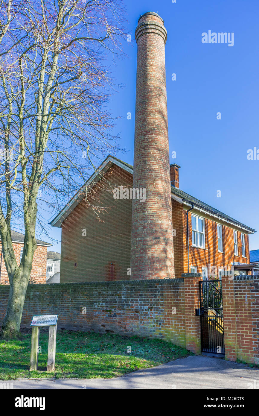 Red brick residential building with tall chimney along Oram's arbour in Winchester February 2018, England, UK Stock Photo