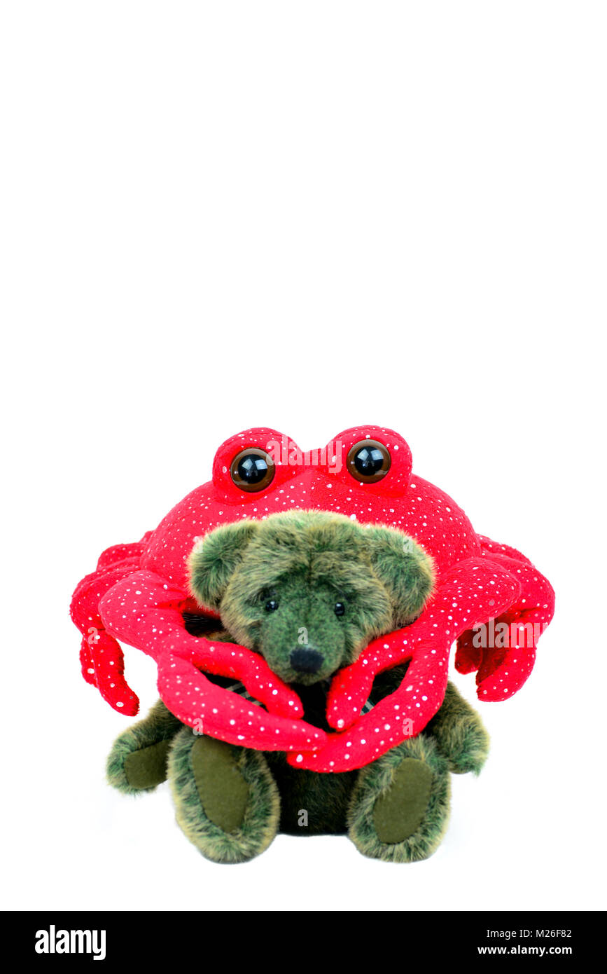 This green bear with a red crab around his neck is isolated on a white background. Stock Photo