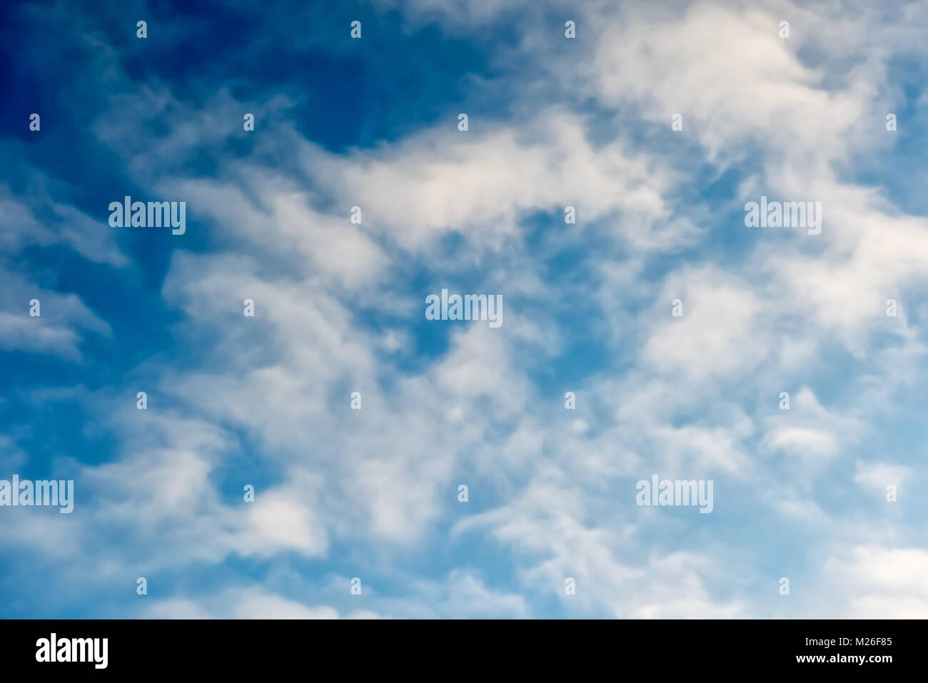 Beautiful natural bright blue sky background with white fluffy clouds. Concept of peacefull sunny day. Stock Photo