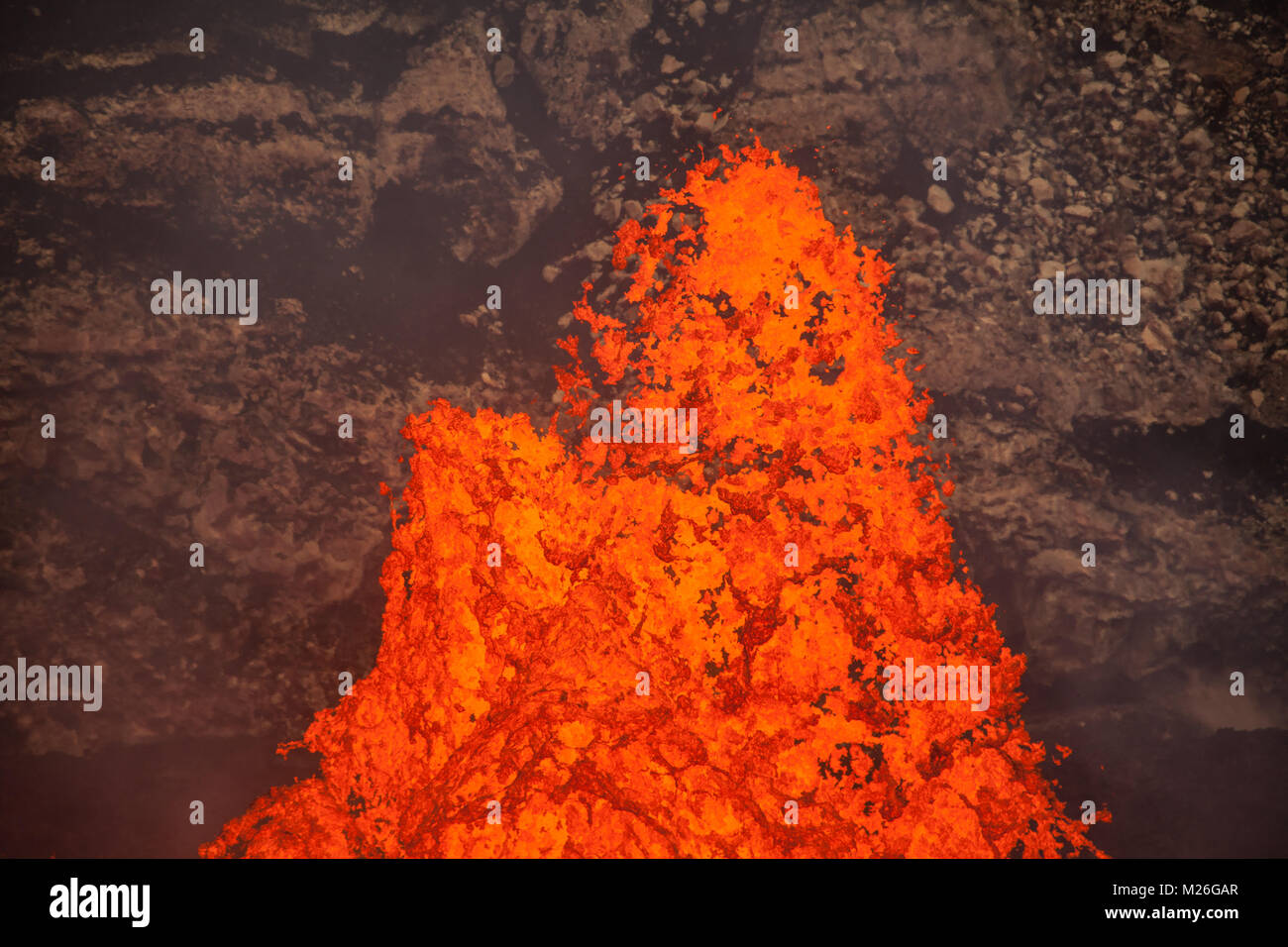 Magma erupts out of the Benbow crater, becoming lava inside the volcano with one of the worlds few permanent lava lakes, Ambrym island, Vanuatu. Stock Photo