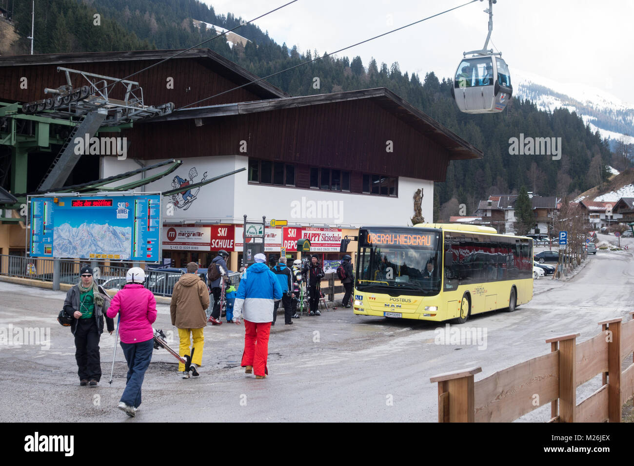 Skiers, ski lift and bus, Niederau village, Alpbach, Tirol, Austria Europe Stock Photo