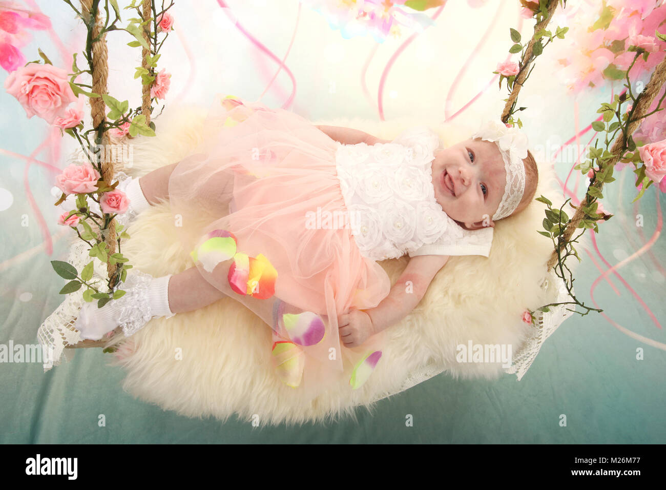 11 week old baby girl on sensory swing in the nursery Stock Photo Alamy