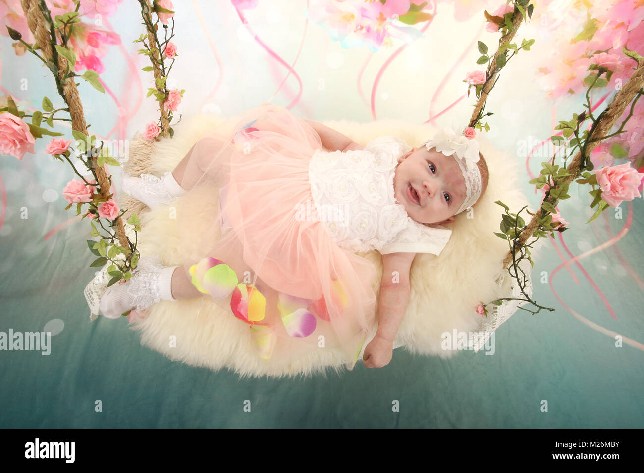 11 week old baby girl on sensory swing in the nursery Stock Photo Alamy