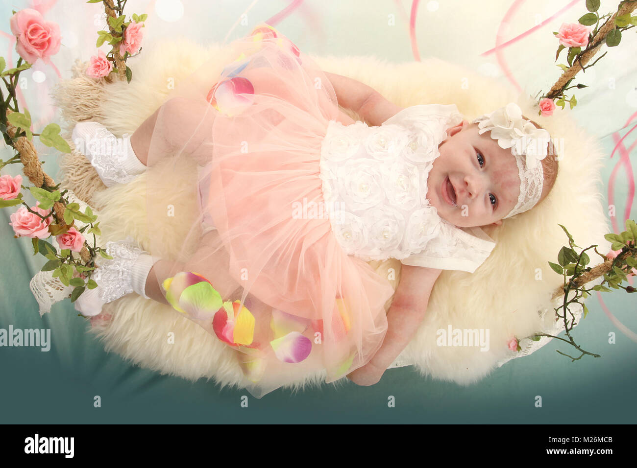 11 week old baby girl on sensory swing in the nursery Stock Photo Alamy