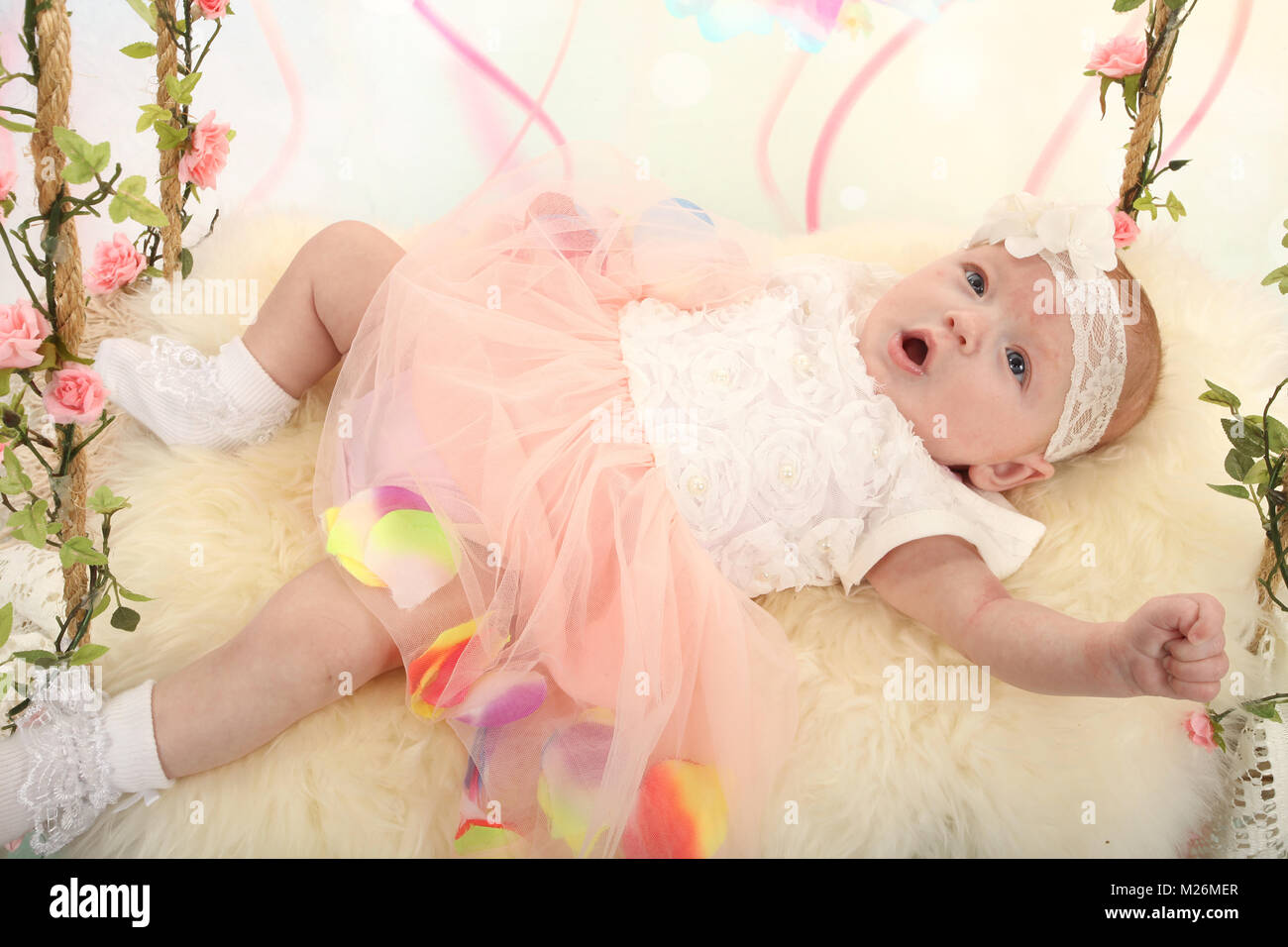 11 week old baby girl on sensory swing in the nursery Stock Photo Alamy