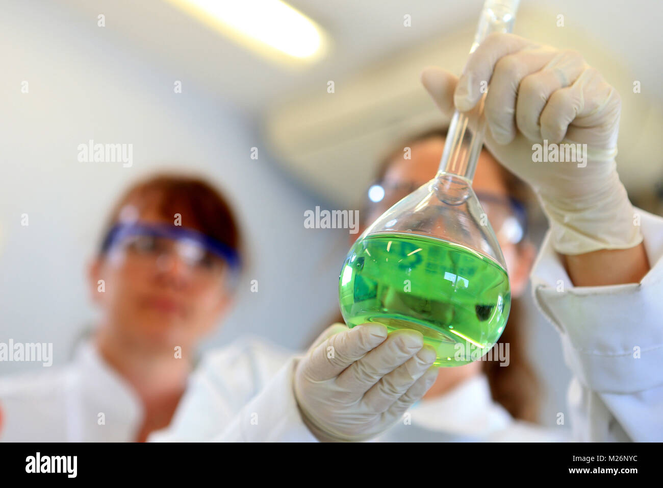 Chemical laboratory man manipulating some flasks Stock Photo