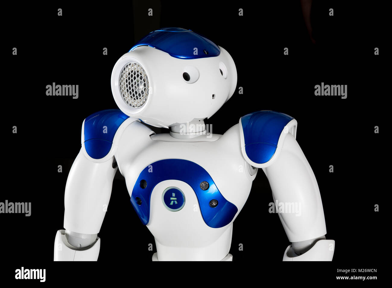 A white and blue robot looks upwards Stock Photo - Alamy