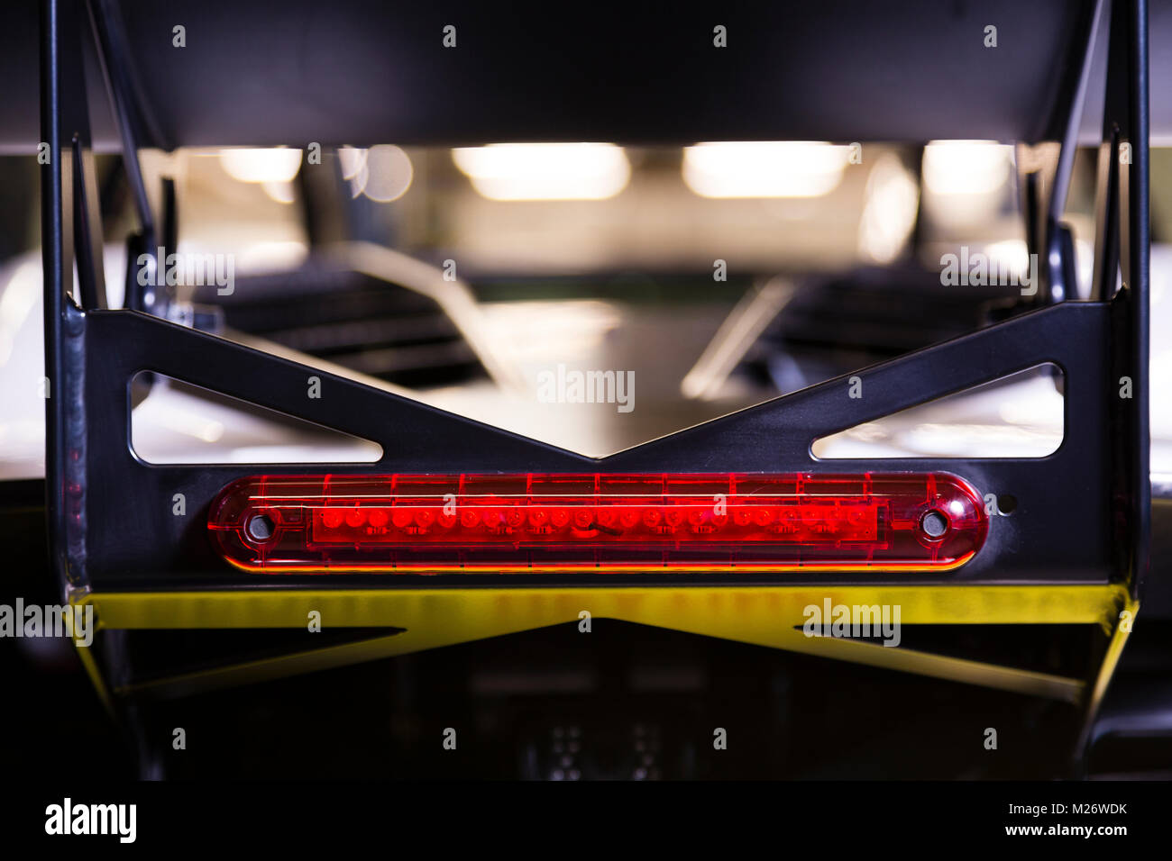 Rear view of the brake light beneath the spoiler of a sports car. Stock Photo