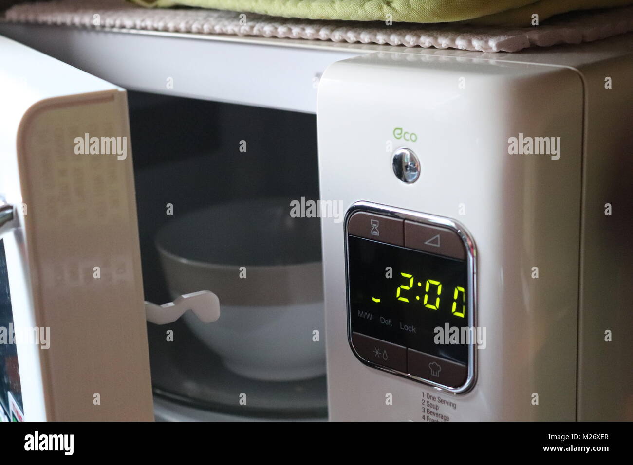 Microwave oven with door open cooking food in the kitchen Stock Photo