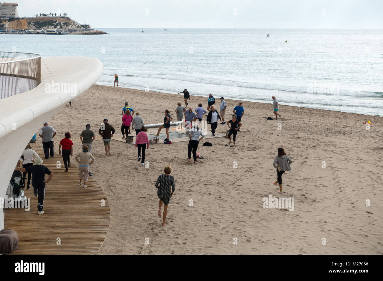 Seniors keeping fit on the beach in Benidorm, Spain. Men women oap's, elderly fitness class Stock Photo