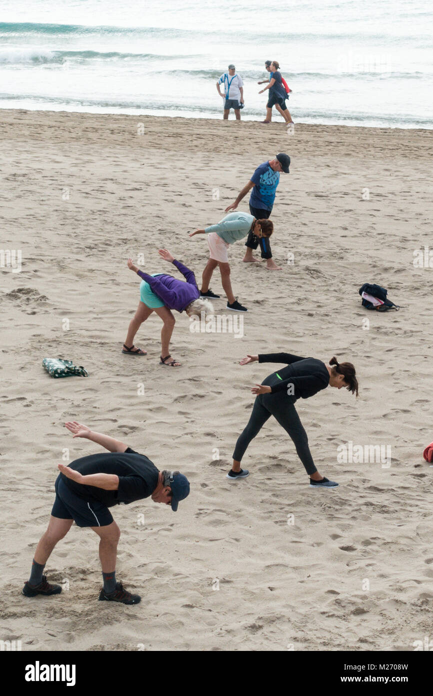 Seniors keeping fit on the beach in Benidorm, Spain. Men women oap's, elderly fitness class Stock Photo