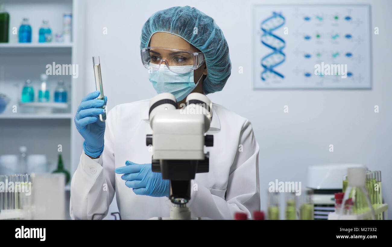 Laboratory scientist doing bacteriological test, looking at tube with