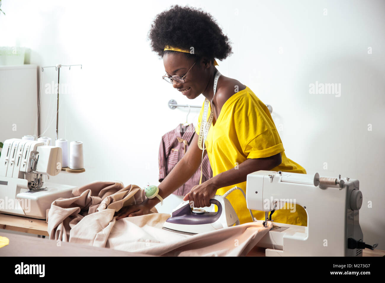 african Woman seamstress Ironing cloth Stock Photo